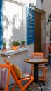 Orange Wooden Chairs and Brown and Black Table