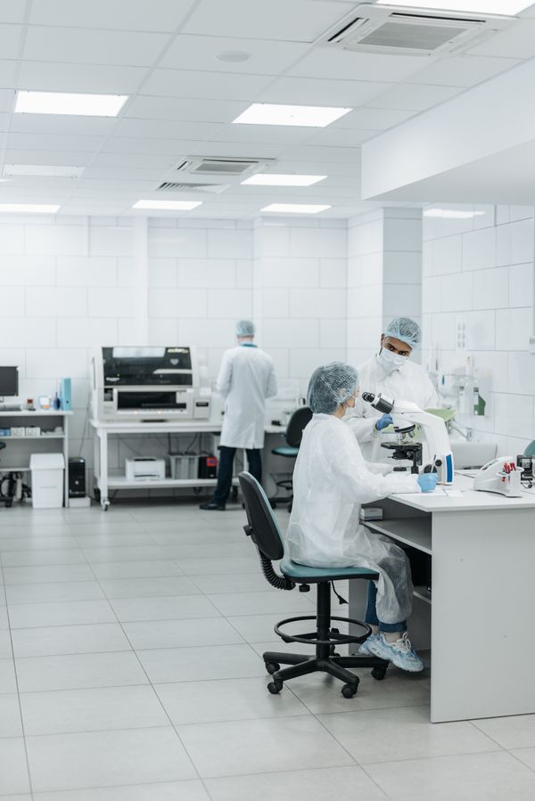 Scientists in semiconductor cleanroom lab — service decision frameworks for industrial operations