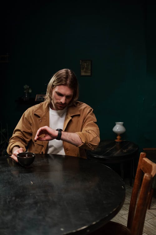 A Man Looking at the Time on His Wristwatch