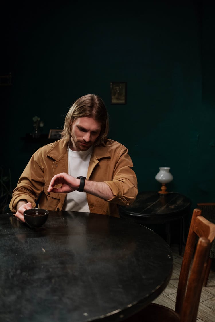 A Man Looking At The Time On His Wristwatch