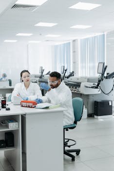 Scientists engaged in research and analysis of samples in a modern laboratory setting.