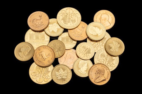 Free Gold Round Coins on Black Surface  Stock Photo