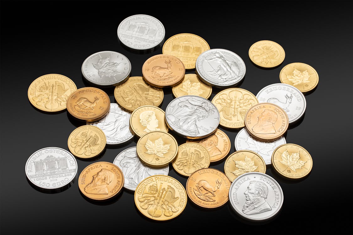 Silver and Gold Coins over a Black Surface