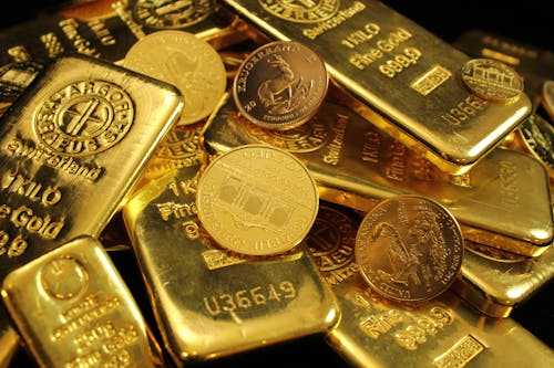 Close-up Photo of Gold Bars and Coins