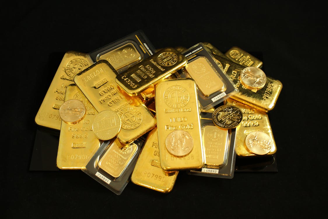 Free Gold Bars and Coins on a Black Surface Stock Photo