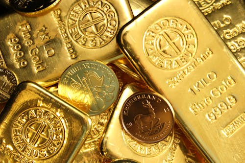 Close-Up Shot of Gold Bars and Coins