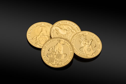 Free Gold Round Coins on Black Surface  Stock Photo
