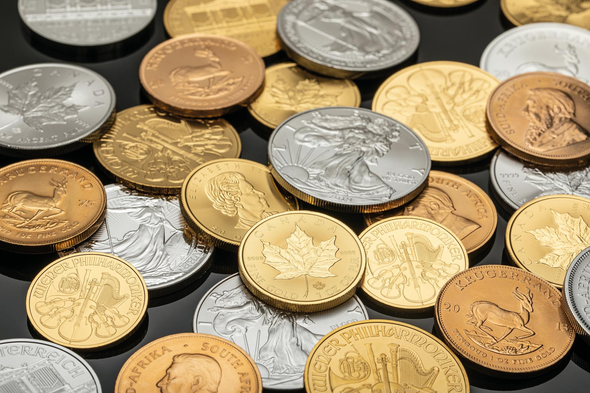 A detailed view of various gold and silver coins, ideal for financial themes.