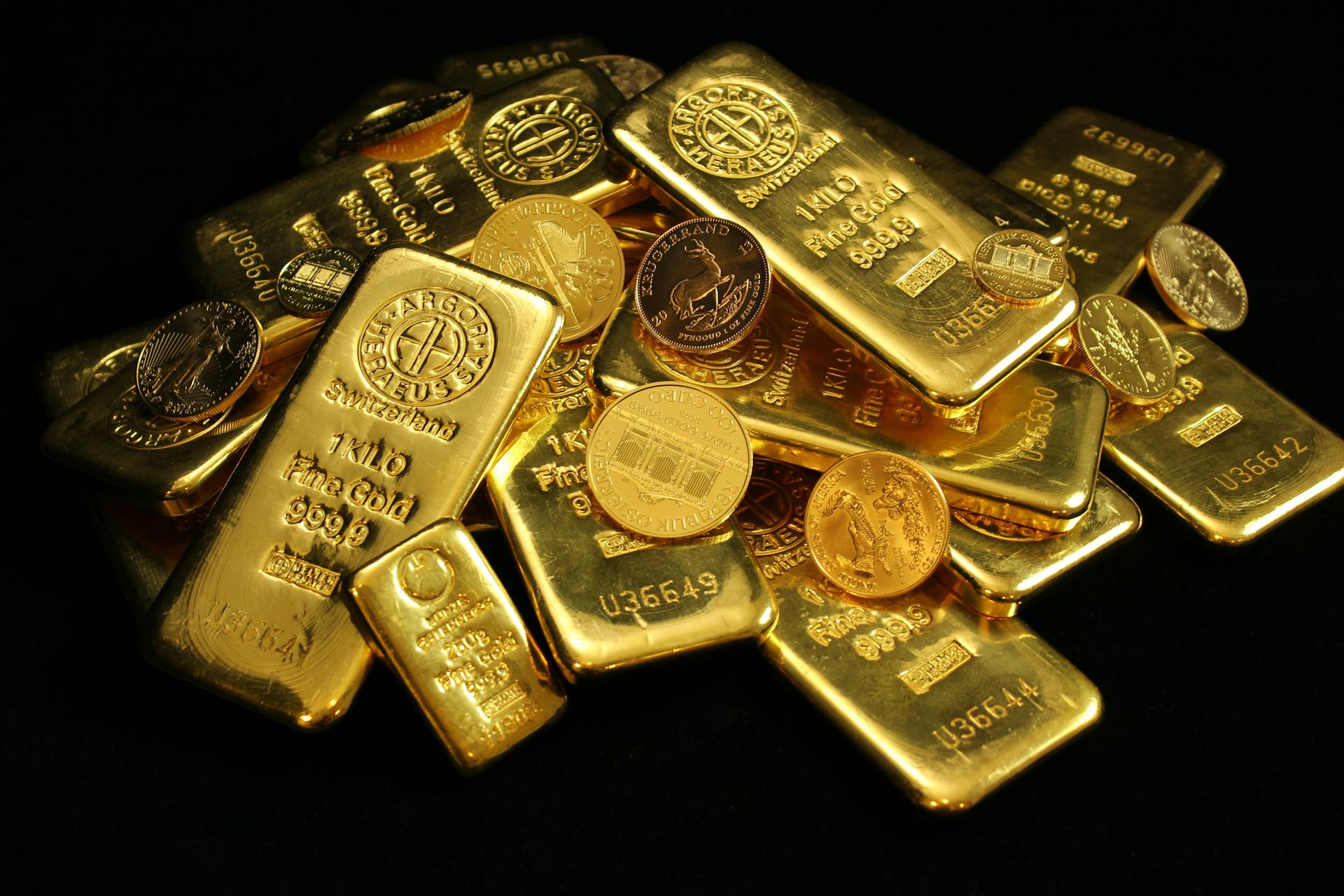 A collection of shining gold bars and coins symbolizing wealth and investment.