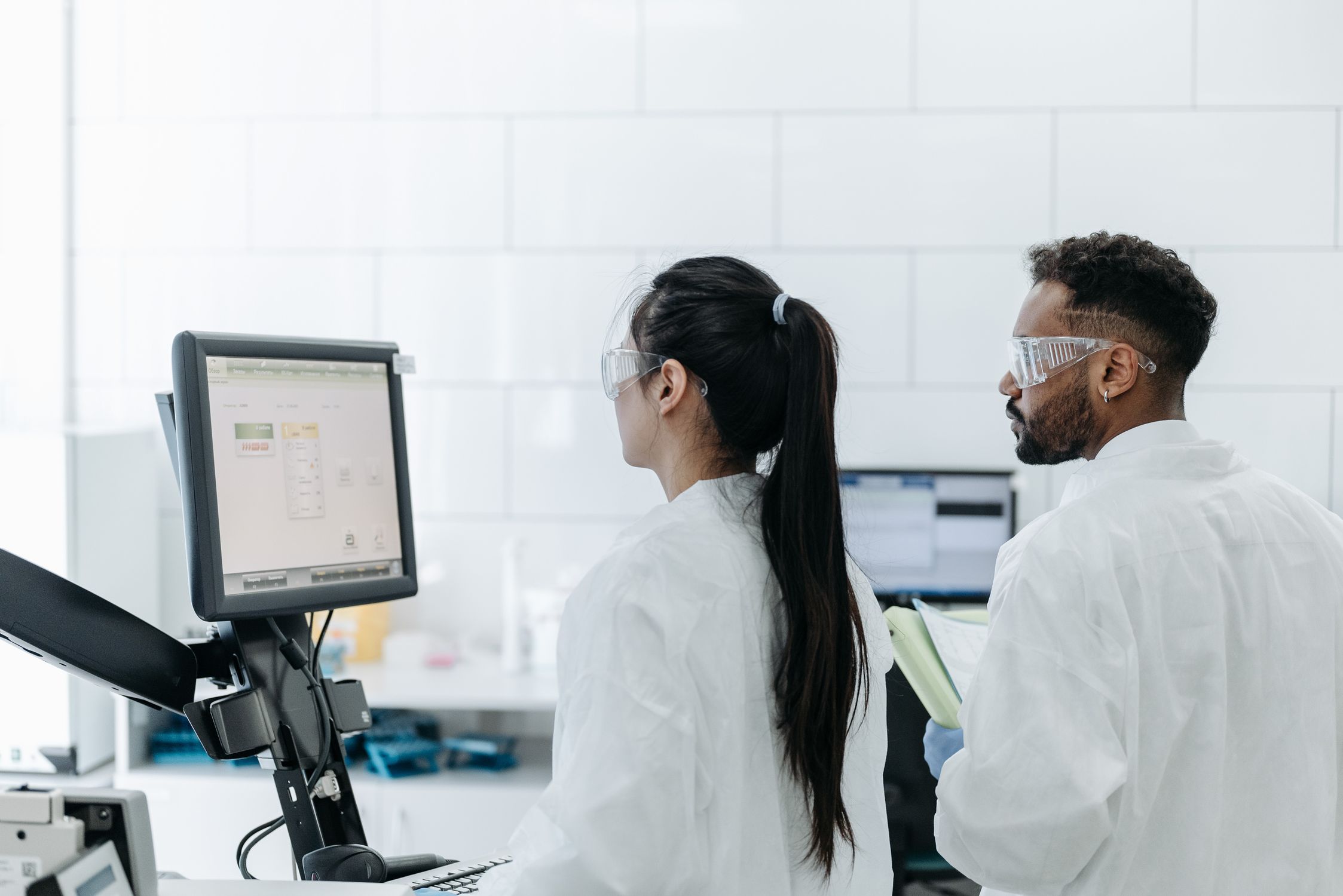 Laboratory Assistants Looking at Monitor Screen · Free Stock Photo