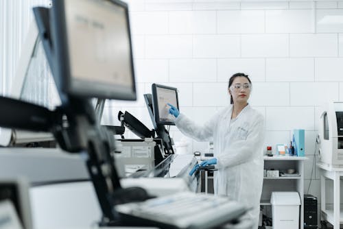Female Medical Practitioner standing in front of a Monitor 