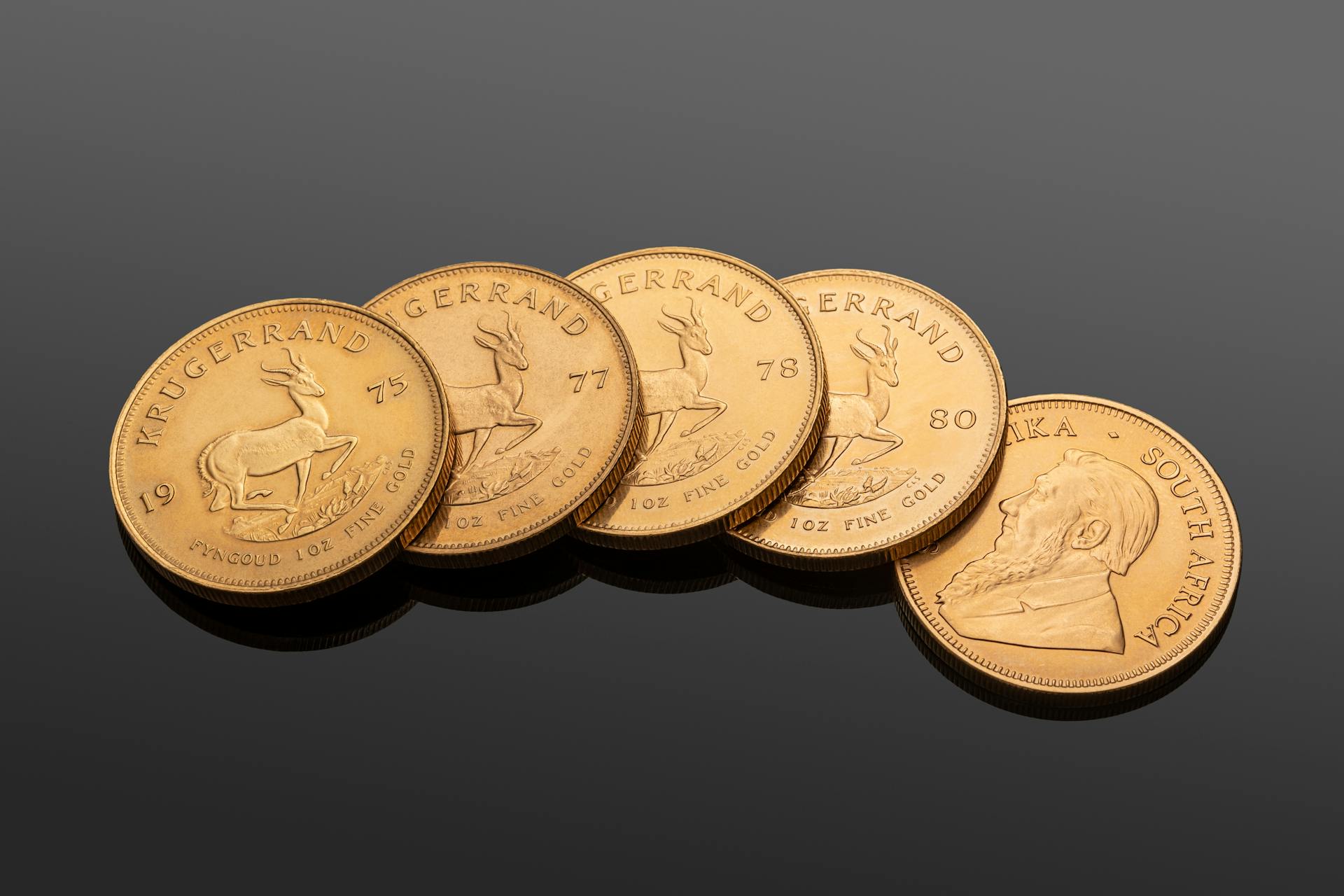 Detailed view of South African Krugerrand gold coins for investment and currency exchange.