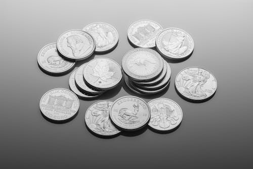 Free Silver Round Coins on Gray Surface Stock Photo