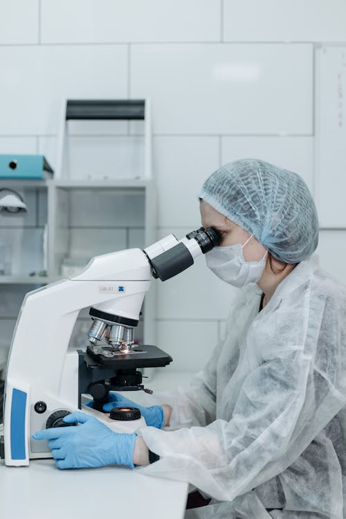 Side View of a Woman using Microscope