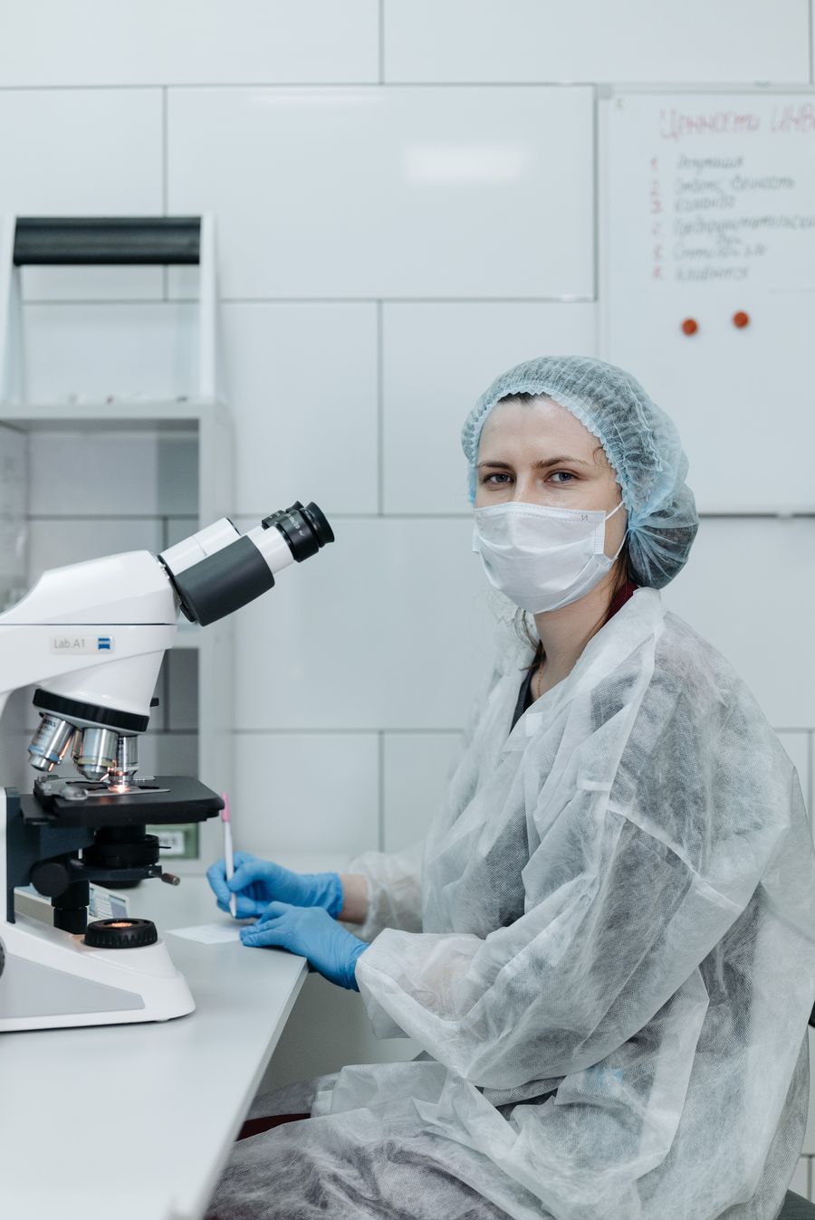 Laboratory technician reviewing microscope work