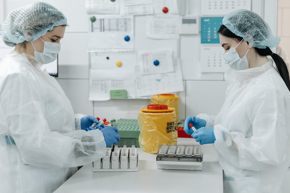 Free Female Medical Practitioner looking at Test Tubes Samples Stock Photo