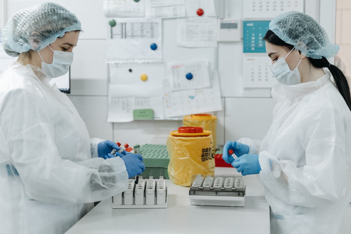Laboratory technicians analyzing samples in a medical lab setting, highlighting modern healthcare processes. Illustrative editorial photograph.