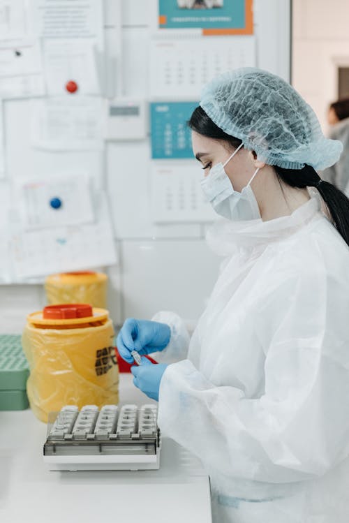 Free Female Medical Practitioner looking at Samples Stock Photo