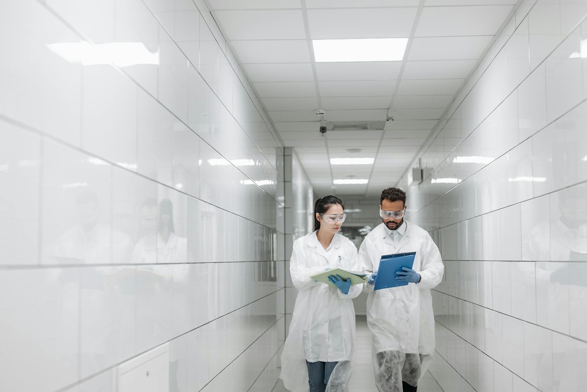 Medical Professional Wearing Personal Protective Equipment Walking in a Hallway