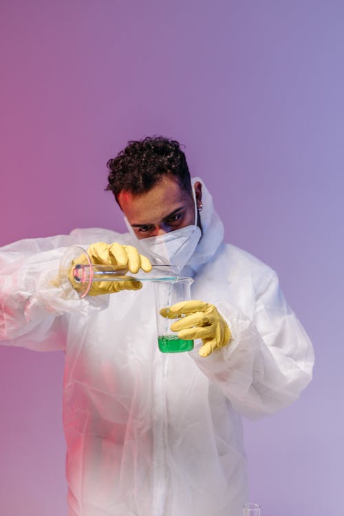 Man Wearing Lab Coat and Protective Gloves and Gloves