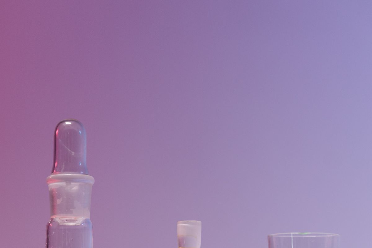 Colored liquid samples in laboratory flasks representing experimental results data