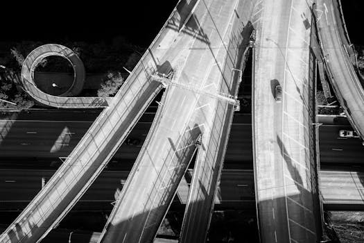 Drone shot showcasing intricate highway overpasses in monochrome.