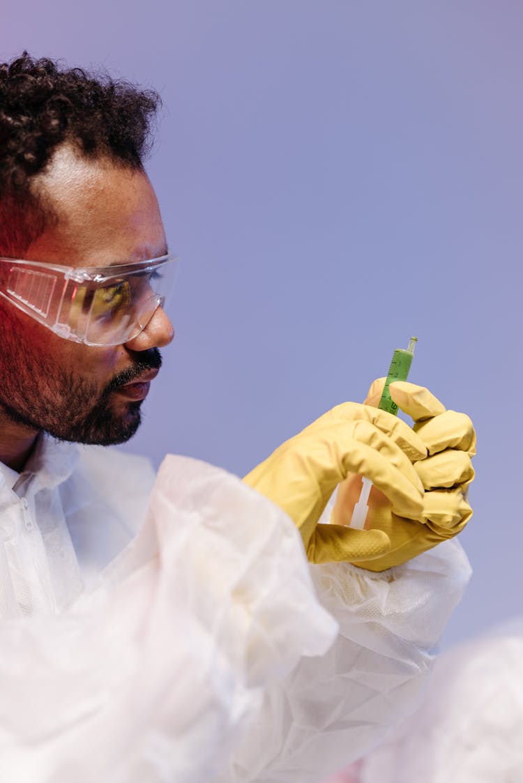 Side View Of A Doctor Holding An Injection