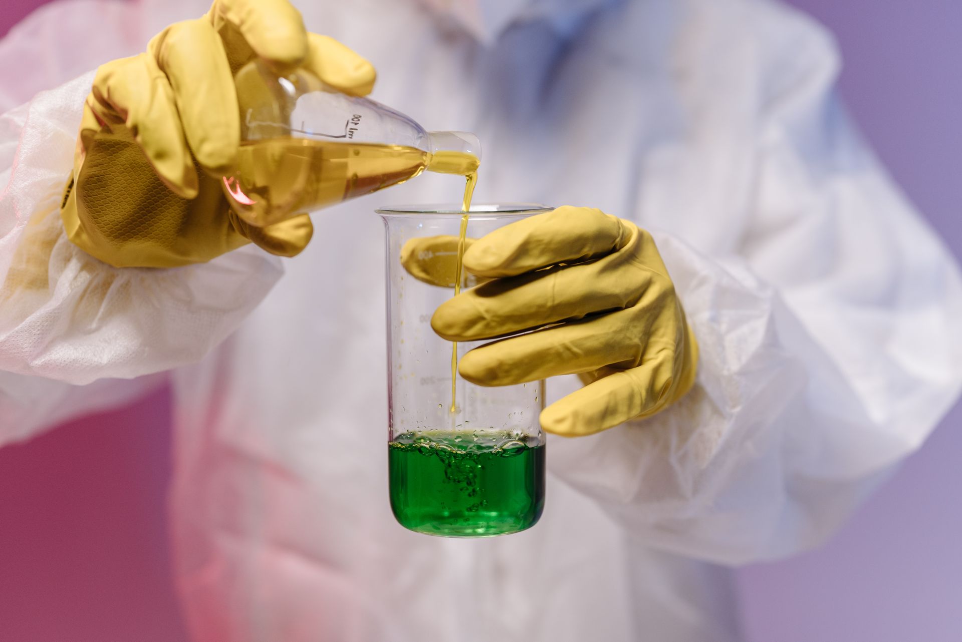 Male Medical Professional pouring Liquid in an Apparatus