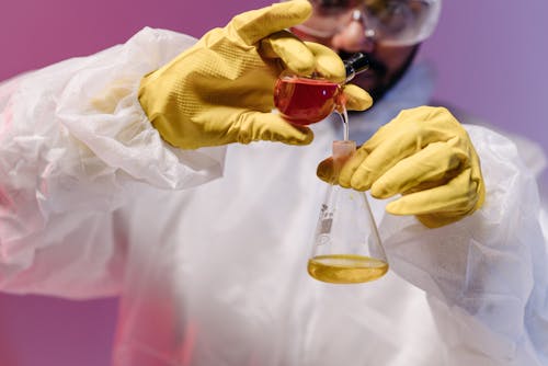 Free a Scientist Mixing Chemicals in Test Tubes Stock Photo