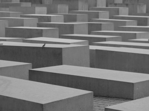 Free Black and white abstract view of geometric concrete blocks with a solitary bird. Stock Photo