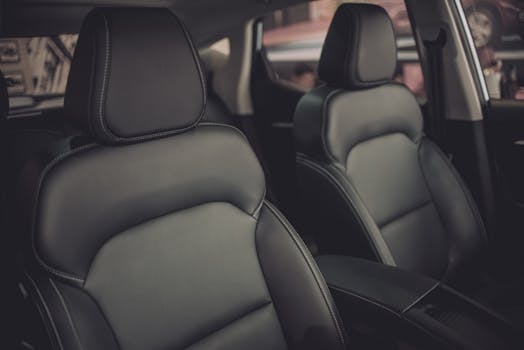 Close-up of luxury car's sleek leather seats, highlighting elegance and comfort.
