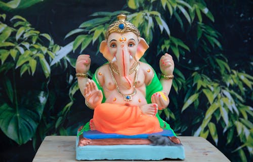 Free Elephant Headed Deity Figurine on Brown Wooden Table Top Stock Photo