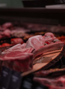 A variety of fresh raw meats on display at a stall in Stralsund market, Germany.