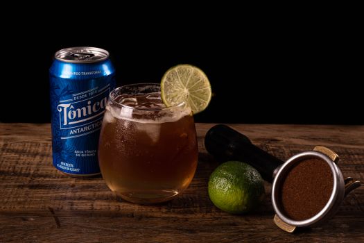 Close-Up Shot of a Glass of Drink beside a Can