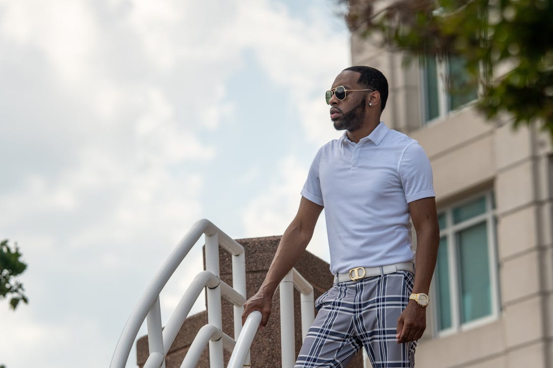 Man in White Polo Shirt and Plaid Pants Wearing Black Sunglasses