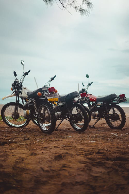 Free Photograph of Motorcycles Parked on a Dirt Road Stock Photo