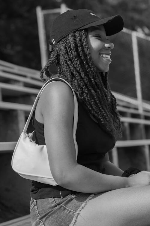 Smiling Female Teenager Sitting on the Bench