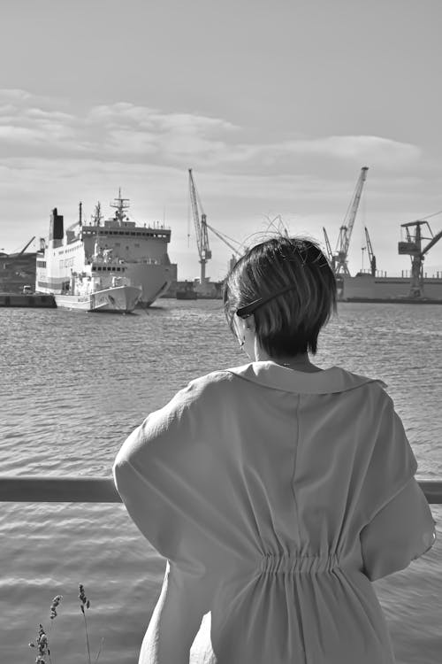 Free Monochrome Photo of a Woman Looking at a Ship Stock Photo