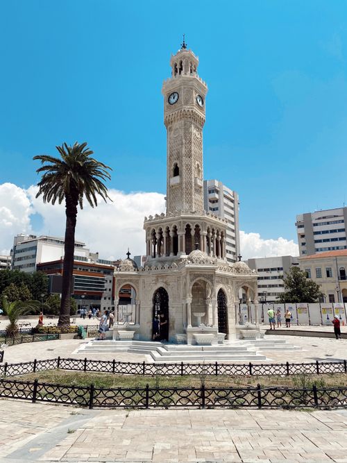 Free Elegant Ottoman-era clock tower in sunny urban park setting. Stock Photo