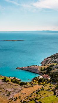 Explore the breathtaking coastal seascape of Krk, Croatia from above, capturing the vibrant blues and lush landscapes.