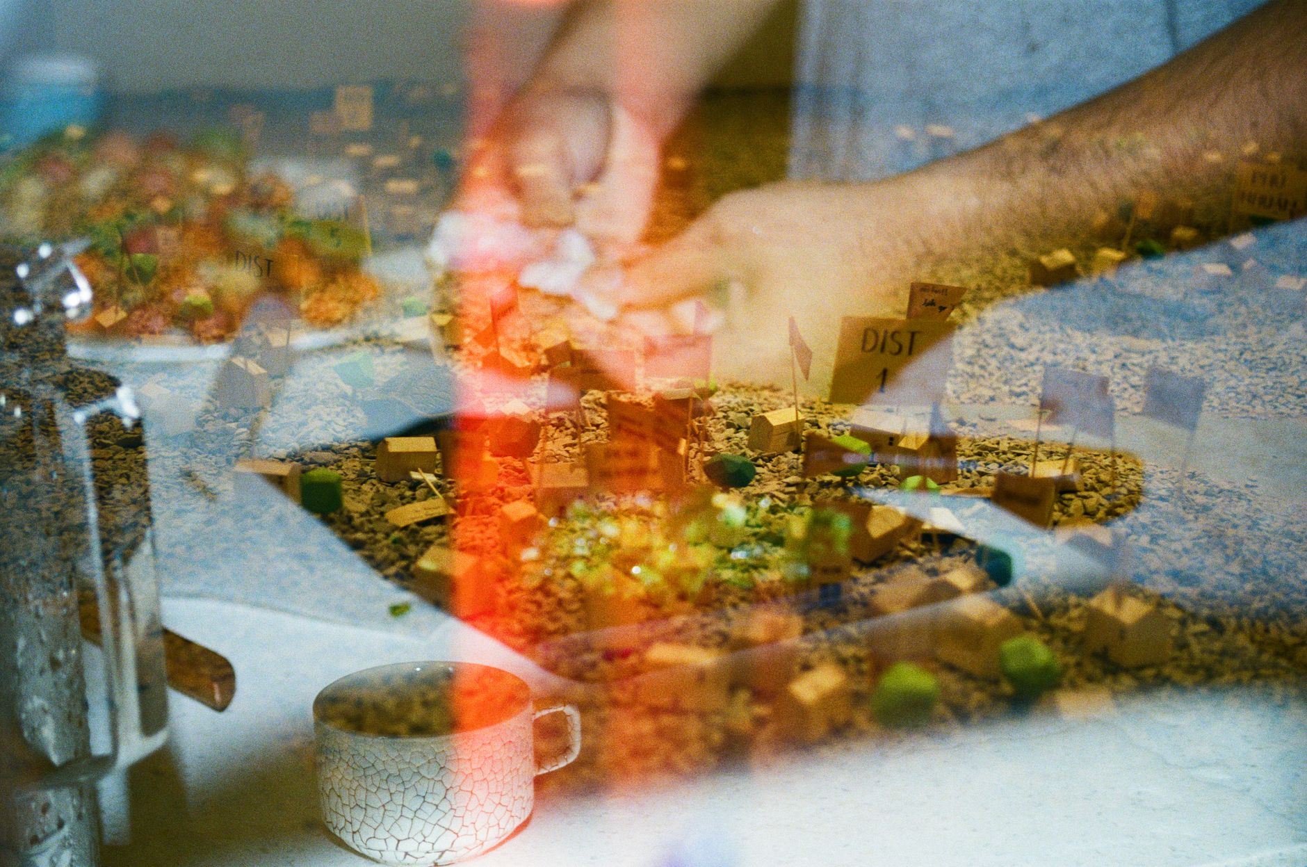 Creative double exposure image blending hands crafting with a miniature scene.