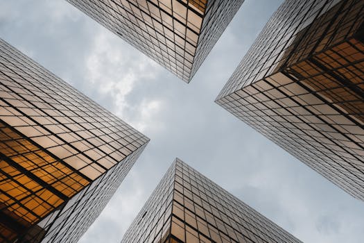Low-angle view of reflective skyscrapers against the sky in Kowloon, Hong Kong.