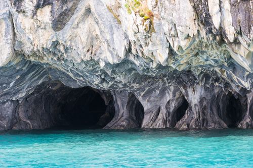 Free Stunning marble caves located in Chilean Patagonia showcasing unique geological formations over turquoise waters. Stock Photo