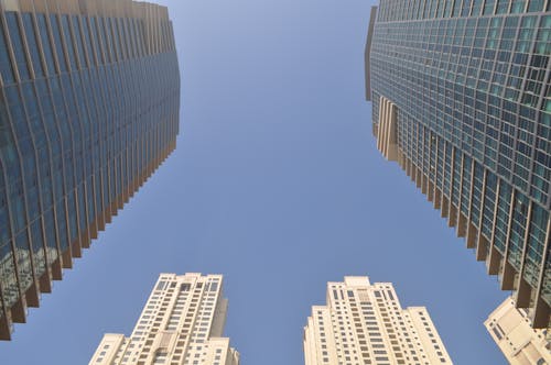 Two Gray-and-blue Glass Buildings