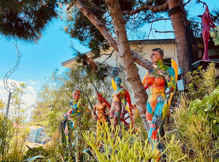 Painted Colorful Mannequins Under The Trees