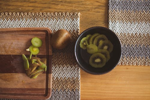 Free Slices of Kiwi in a Bowl on Wooden Table Stock Photo