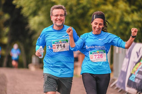 Free Man and Woman in Blue Shirt Running Stock Photo