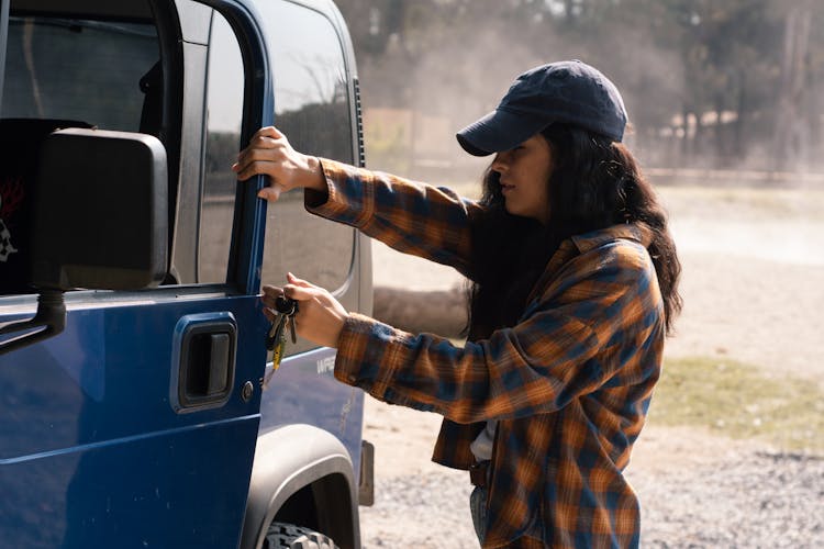 Woman Opening The Door Of A Truck 