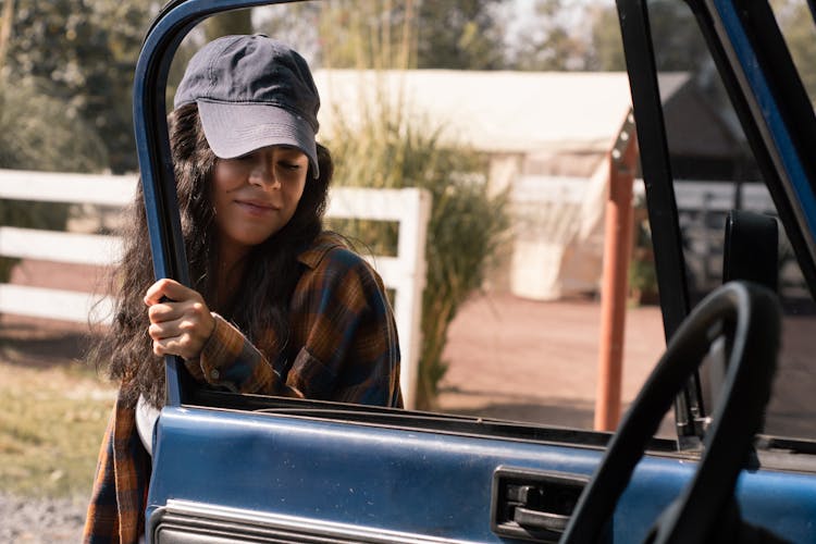 Woman Opening The Door Of A Truck 