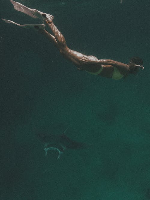 Free Woman in White Bikini Swimming Under Water Stock Photo
